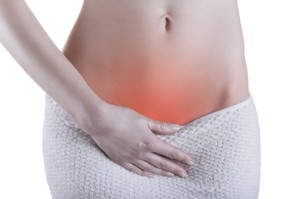 Close up of a woman's abdomen with menstrual pain isolated on white background
